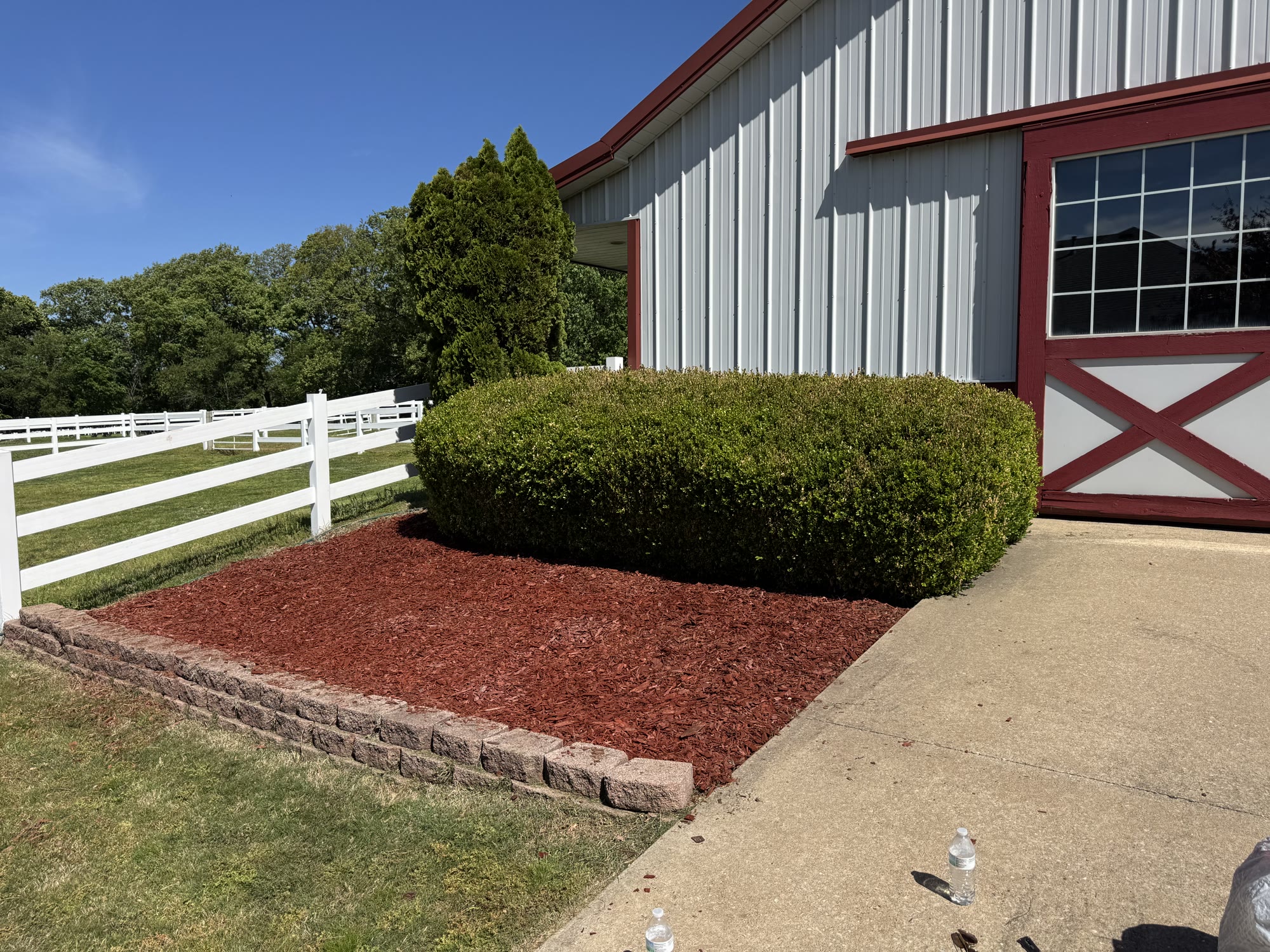 Outbuilding landscape bed after fresh mulch
