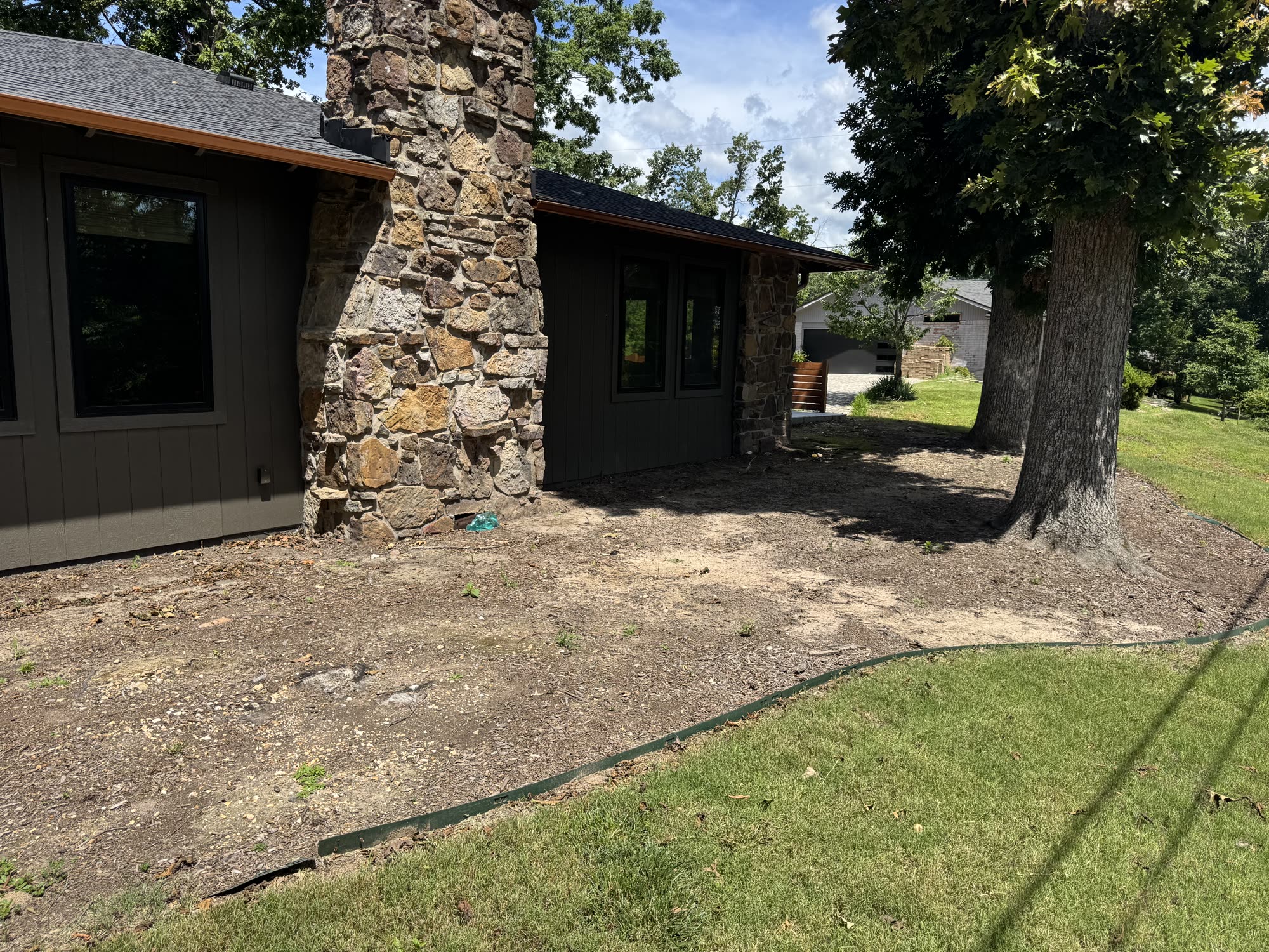 Stone home landscape before renovation